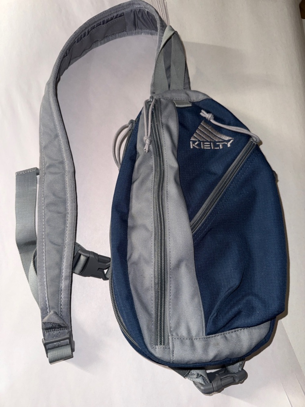 Kelty Sling bag is a compact over-the-shoulder everyday carry bag blue and grey
